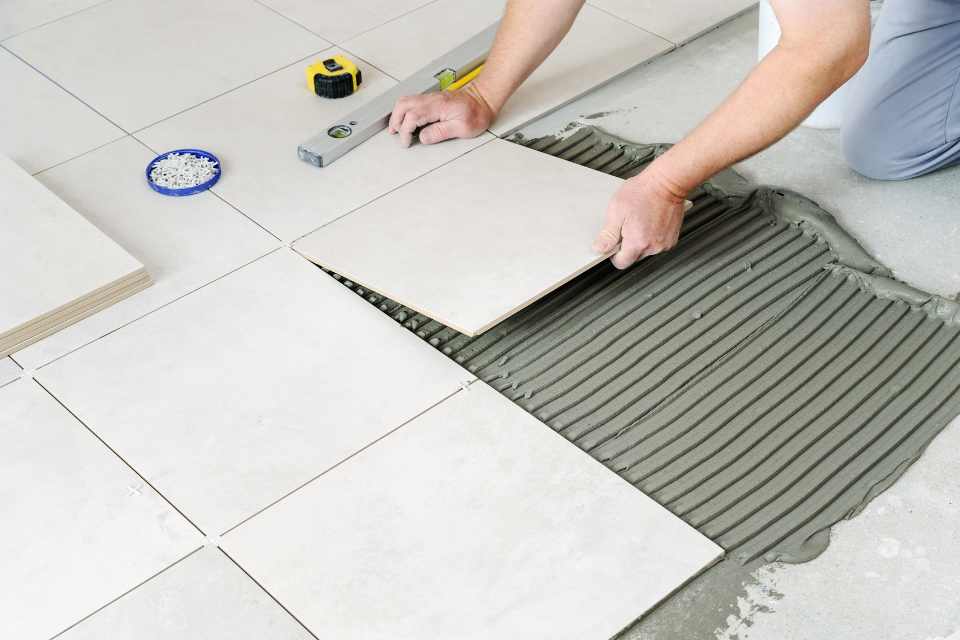 professional tile installation with grout and tools